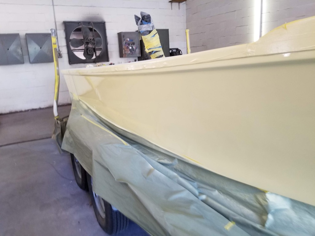 Cream colored boat hull paint application