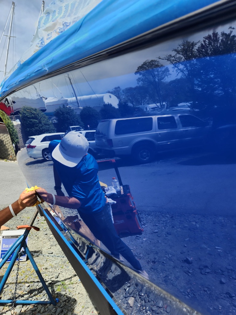 Professional craftsman restoring yacht paint and gelcoat