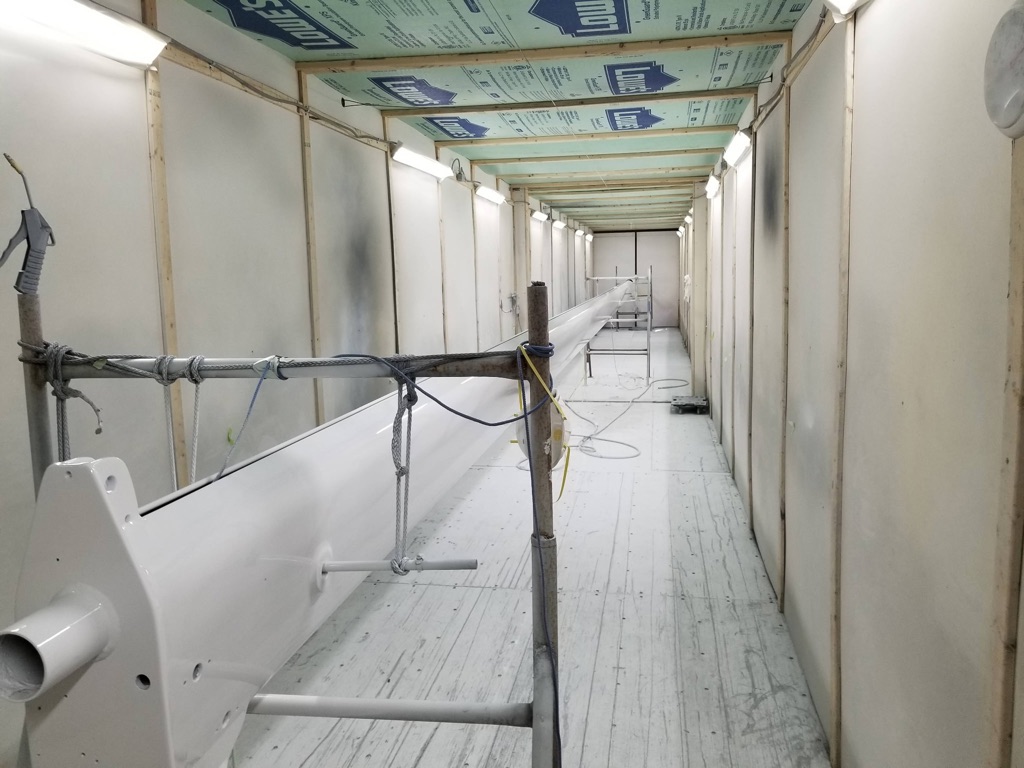 Inside professional paint booth with boat