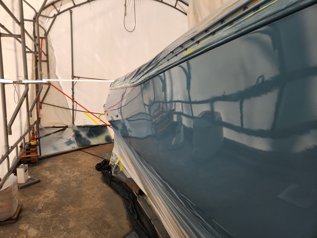 Teal boat hull paint in progress